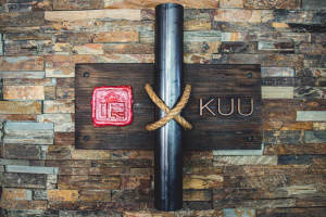 KUU sign on the wall with a pipe